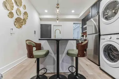 a kitchen with a counter and a washer and dryer at Stylish Studio Sleeps Four - 10 mins to DT (B) in Philadelphia