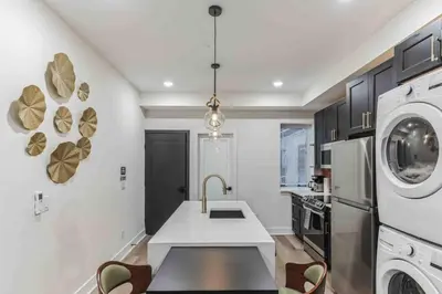a kitchen with a sink and a washer and dryer at Stylish Studio Sleeps Four - 10 mins to DT (B) in Philadelphia