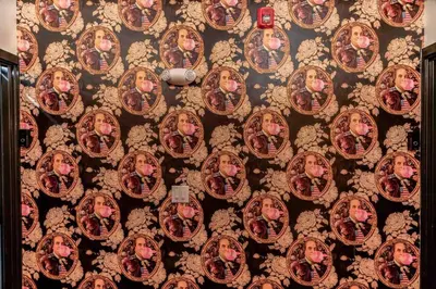 a wall with a bunch of pictures on it at Stylish Studio Sleeps Four - 10 mins to DT (B) in Philadelphia