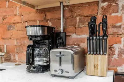 a coffee maker sitting on a counter next to a knife block at Stylish Studio Sleeps Four - 10 mins to DT (B) in Philadelphia