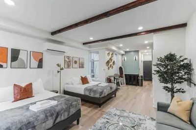 a bedroom with two beds and a living room at Large Studio w 2 Beds and Balcony (C) in Philadelphia