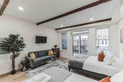 a living room with a bed and a couch at Large Studio w 2 Beds and Balcony (C) in Philadelphia