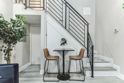 a dining room with a table and two chairs at Large Bi-Level 2BR Loft in Old City that Sleeps 8 in Philadelphia