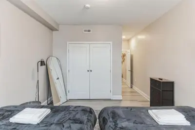 a white room with two beds and a surfboard at Large Bi-Level 2BR Loft in Old City that Sleeps 8 in Philadelphia