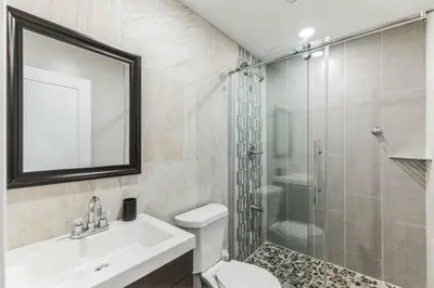 a bathroom with a sink toilet and a shower at Large 2BR in Old City that Sleeps 8 in Philadelphia