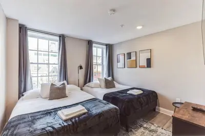 a hotel room with two beds and a window at Large 2BR in Old City that Sleeps 8 in Philadelphia