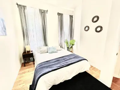 a white bedroom with a bed and a window at Incredible Location - Large Center City 2 BR in Philadelphia