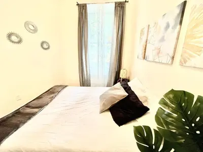 a bedroom with a large bed with a window at Incredible Location - Large Center City 2 BR in Philadelphia