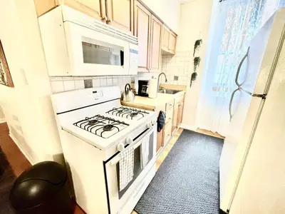 a kitchen with a white stove and a microwave at Incredible Location - Large Center City 2 BR in Philadelphia
