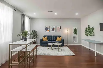 a living room with a blue couch and a table at Large and Sunny 1BR - Center City - Sleeps 4 in Philadelphia