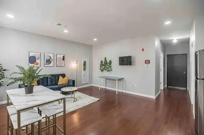 a living room with a couch and a table at Large and Sunny 1BR - Center City - Sleeps 4 in Philadelphia