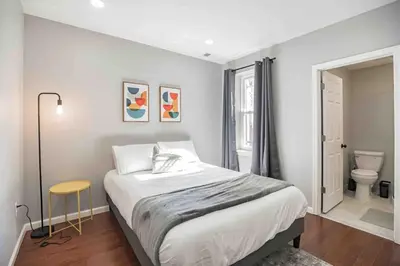 a white bedroom with a bed and a toilet at Large and Sunny 1BR - Center City - Sleeps 4 in Philadelphia