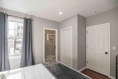 a bedroom with a bed and a window and a shower at Large and Sunny 1BR - Center City - Sleeps 4 in Philadelphia