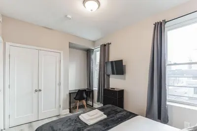 a bedroom with a bed and a window at Bi-Level 2BR Loft in Old City in Philadelphia