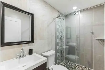 a bathroom with a shower and a sink and a toilet at Bi-Level 2BR Loft in Old City in Philadelphia