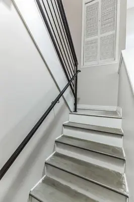 a metal staircase with a window in a house at Bi-Level 2BR Loft in Old City in Philadelphia