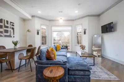 a living room with a blue couch and a table at 2BR - Across from Fairmount Park -10 mins to DT in Philadelphia