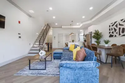a living room with a blue couch and a table at 2BR - Across from Fairmount Park -10 mins to DT in Philadelphia