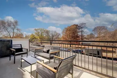 a balcony with benches and a view of a train at 2BR - Across from Fairmount Park -10 mins to DT in Philadelphia