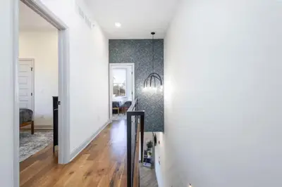 a hallway of a home with white walls and wooden floors at 2BR - Across from Fairmount Park -10 mins to DT in Philadelphia