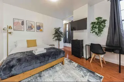 a bedroom with a bed and a desk and a piano at Cozy Studio across from Convention Center - 4R in Philadelphia