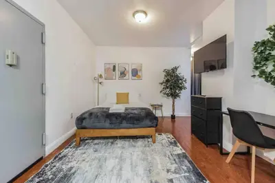 a bedroom with a bed and a desk at Cozy Studio across from Convention Center - 4R in Philadelphia