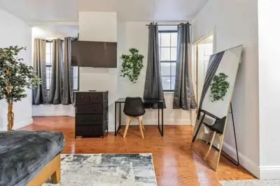 a bedroom with a bed and a desk and a chair at Cozy Studio across from Convention Center - 4R in Philadelphia