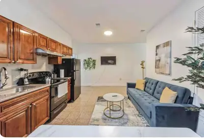 a kitchen and living room with a blue couch at Across from Convention Center - Sleeps 6 - 3F in Philadelphia