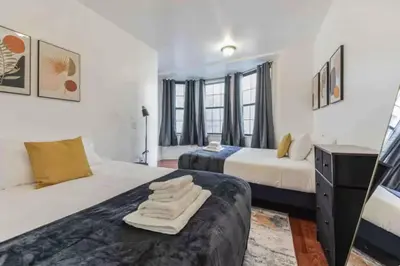 a hotel room with two beds and a desk at Across from Convention Center - Sleeps 6 - 3F in Philadelphia