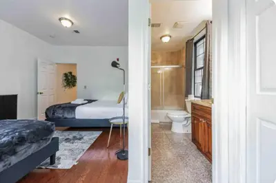 a bedroom with a bed and a bathroom with a toilet at Across from Convention Center - Sleeps 6 - 3F in Philadelphia