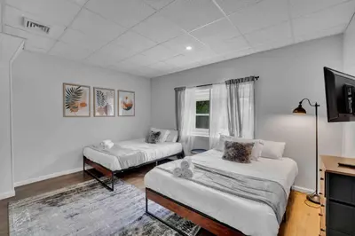 a room with two beds and a flat screen tv at BRAND NEW Modern 2BR - Heart of Center City in Philadelphia
