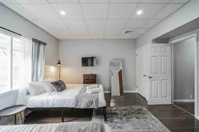 a bedroom with a large bed and a window at BRAND NEW Modern 2BR - Heart of Center City in Philadelphia