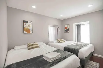 a bedroom with two beds and a window at Cozy 1BR - Center City - Sleeps 4 - 2 Beds in Philadelphia