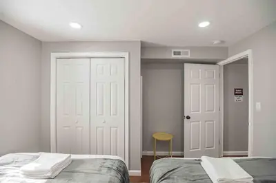 a bedroom with two beds and a white door at Cozy 1BR - Center City - Sleeps 4 - 2 Beds in Philadelphia