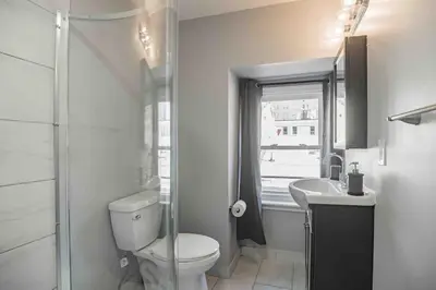 a bathroom with a toilet and a sink and a window at Cozy 1BR - Center City - Sleeps 4 - 2 Beds in Philadelphia