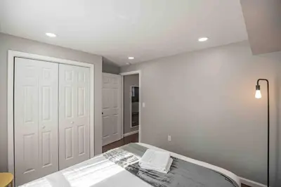 a bedroom with a bed and a white door at Modern and Stylish Center City 1BR - Perfect Location in Philadelphia