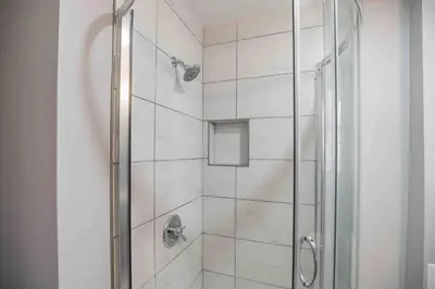 a bathroom with a shower with a glass door at Modern and Stylish Center City 1BR - Perfect Location in Philadelphia