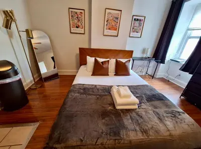 a bedroom with a large bed with a wooden headboard at Prime Location Studio in Center City with Fast Wifi in Philadelphia