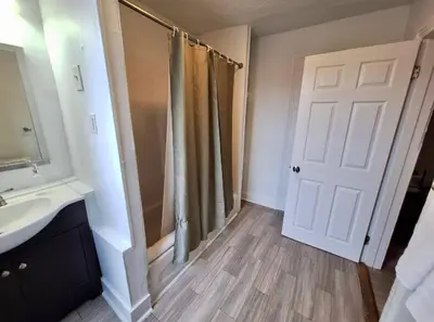 a bathroom with a sink and a white door at Prime Location Studio in Center City with Fast Wifi in Philadelphia