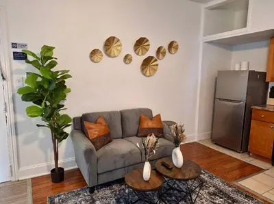a living room with a couch and plates on the wall at Prime Location Studio in Center City with Fast Wifi in Philadelphia