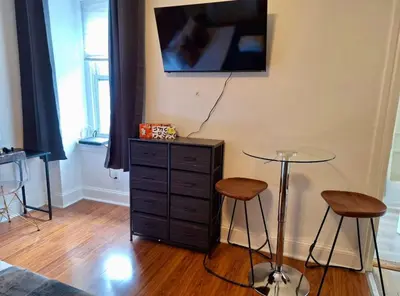 a room with a table and two stools and a tv at Prime Location Studio in Center City with Fast Wifi in Philadelphia