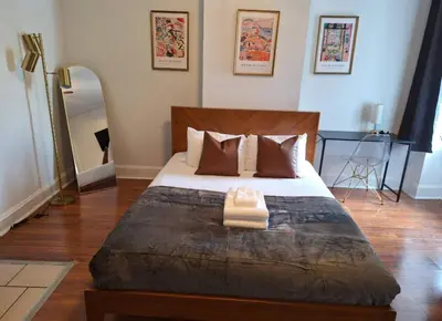 a bedroom with a large bed and a mirror at Prime Location Studio in Center City with Fast Wifi in Philadelphia