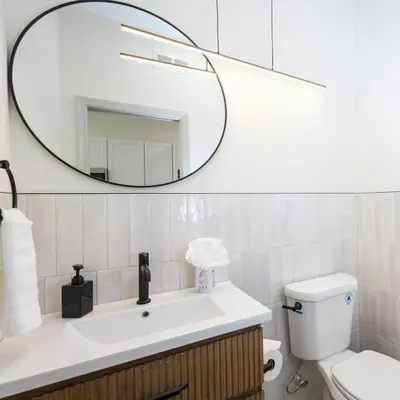 a bathroom with a sink and a mirror at 2BR - Fairmount Park -10 mins to DT - Sleeps 10 in Philadelphia