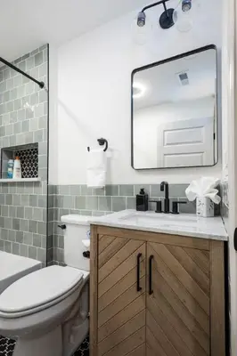 a bathroom with a sink and a toilet and a mirror at 2BR - Fairmount Park -10 mins to DT - Sleeps 10 in Philadelphia