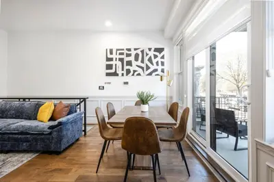 a living room with a table and chairs and a couch at 2BR w Balcony - Fairmount Park - 10 mins to DT in Philadelphia