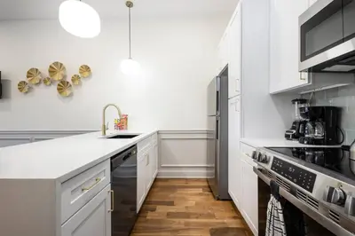 a white kitchen with a sink and a stove at 2BR w Balcony - Fairmount Park - 10 mins to DT in Philadelphia