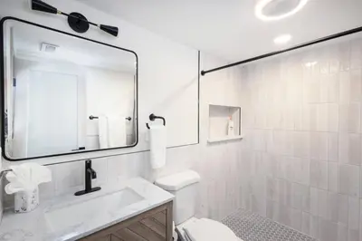 a white bathroom with a sink and a mirror at 2BR w Balcony - Fairmount Park - 10 mins to DT in Philadelphia