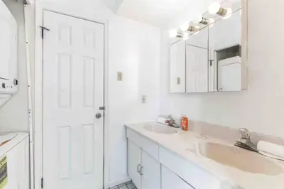 a white bathroom with two sinks and a mirror at Spring Garden Small and Cozy Studio Sleeps 4 in Philadelphia