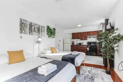two beds in a small room with a kitchen at Spring Garden Small and Cozy Studio Sleeps 4 in Philadelphia