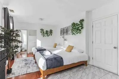 a bedroom with two beds and a white door at Spring Garden Small and Cozy Studio Sleeps 4 in Philadelphia